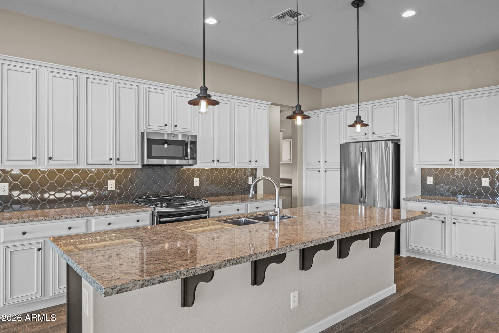 3675 Gold Ridge Road Wickenburg, AZ 85390 - Photo 10 of 58 a kitchen with stainless steel appliances granite countertop a sink a stove and refrigerator