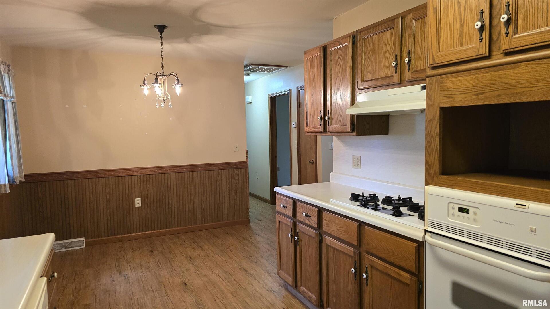 400 Old Broughton Road Eldorado, IL 62930 - Photo 15 of 28 a kitchen with stainless steel appliances granite countertop a stove a refrigerator and a microwave