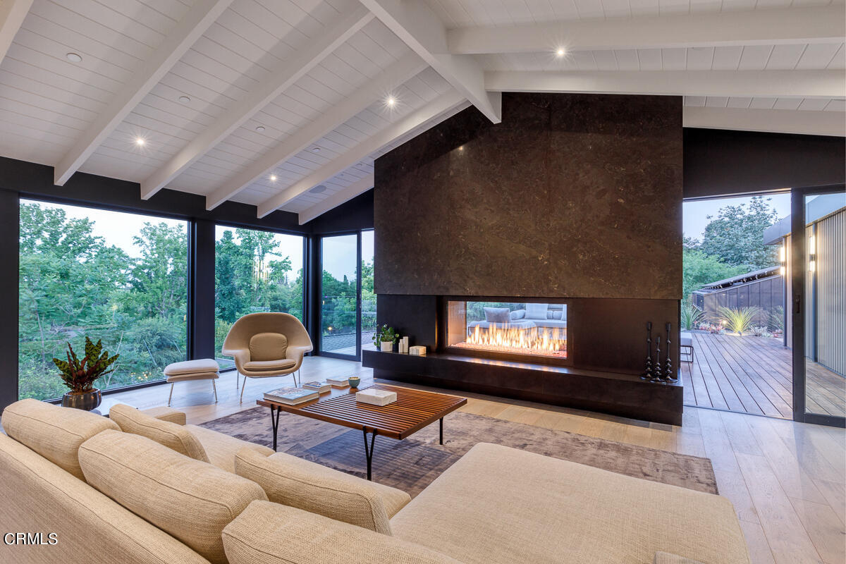 Undisclosed Address Pasadena, CA 91103 - Photo 22 of 74 a living room with furniture a fireplace and a floor to ceiling window