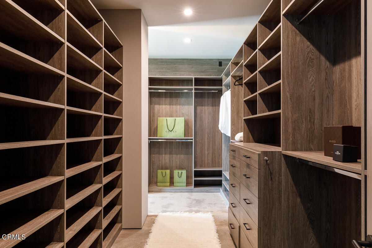 Undisclosed Address Pasadena, CA 91103 - Photo 29 of 74 a view of walk in closet with clothes and shoes