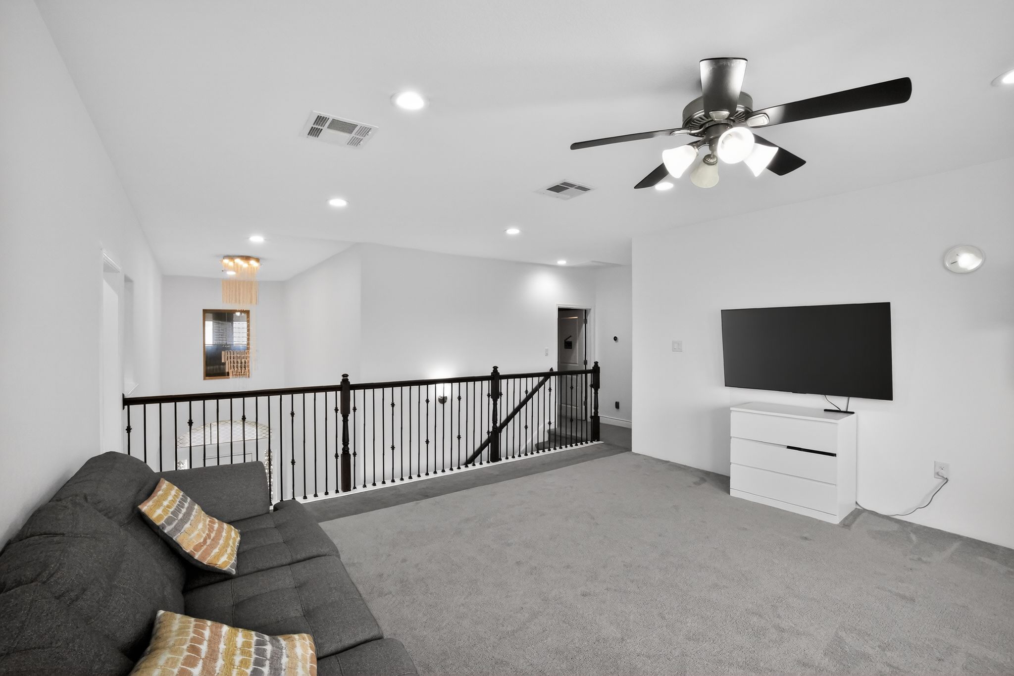400 Cortona Lane Georgetown, TX 78628 - Photo 23 of 40 Living area featuring carpet, ceiling fan, an upstairs landing, and recessed lighting