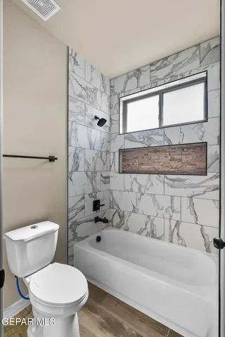 a bathroom with a toilet and a shower