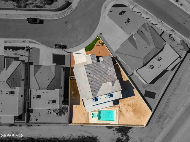 an aerial view of a house with a yard