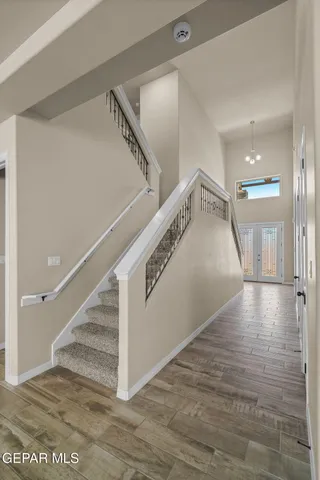 a view of entryway and hall with wooden floor