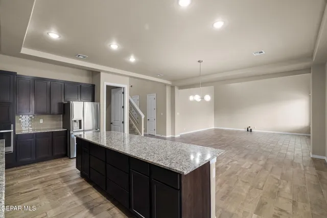 a kitchen with granite countertop a sink and cabinets