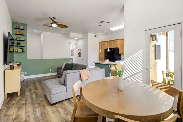 a living room with furniture and a wooden floor