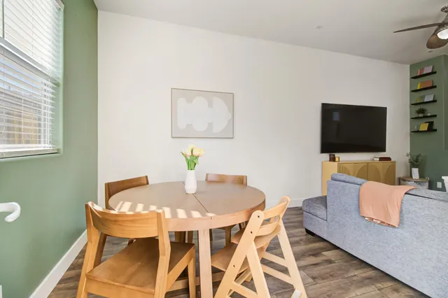 a view of a dining room with furniture and wooden floor