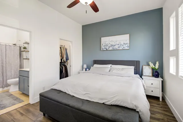 a bedroom with a large bed and a chandelier