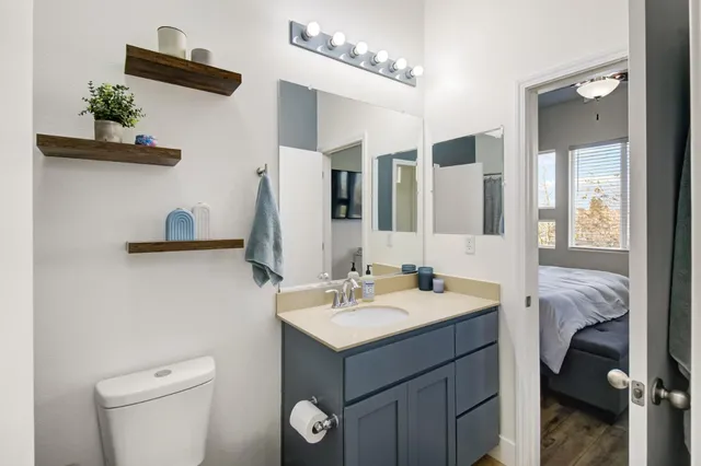 a bathroom with a sink a toilet and mirror
