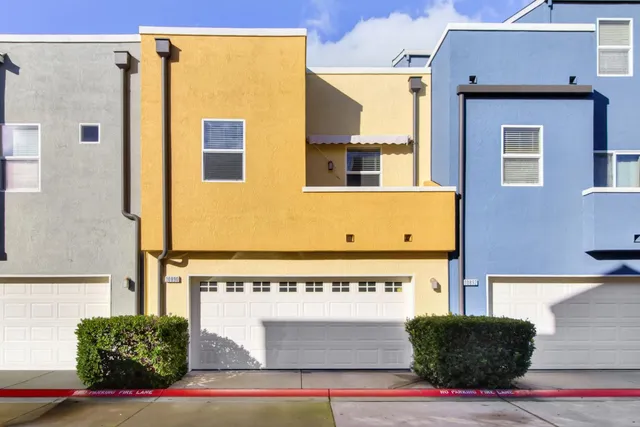 a view of a brick house with many windows