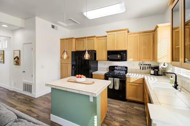 a kitchen with stainless steel appliances a stove microwave and refrigerator