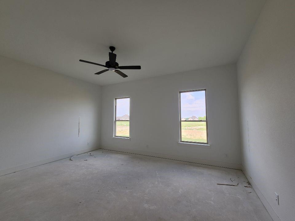 2408 Quartz Street Krum, TX 76249 - Photo 11 of 16 a view of a livingroom with a ceiling fan and window