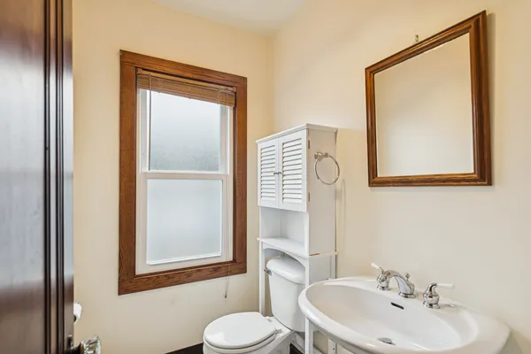 a bathroom with a sink a mirror and a toilet