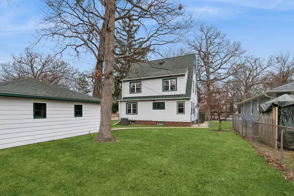 a house that has a tree in front of a house
