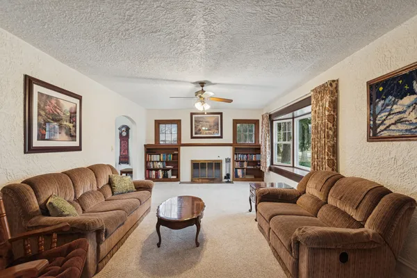 a living room with furniture a fireplace and a flat screen tv