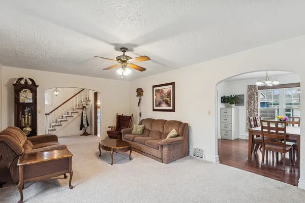 a living room with furniture and a chandelier