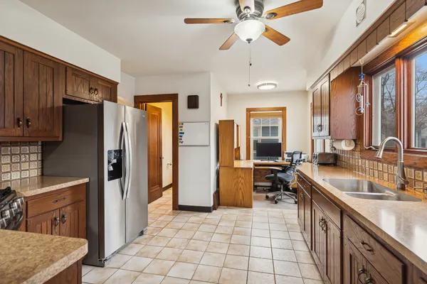 a large kitchen with a large counter top appliances and cabinets