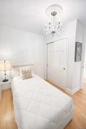 a bed room with a bed television and a couch