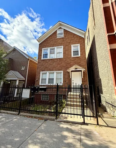 a front view of a house with iron fence
