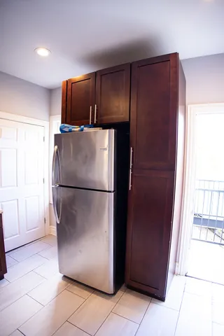 a metallic refrigerator freezer sitting in a kitchen