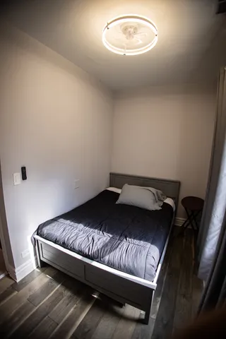 a bedroom with a bed and a chandelier