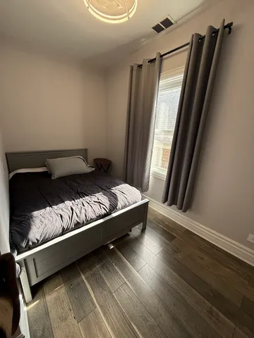 a bed sitting in a bedroom next to a window