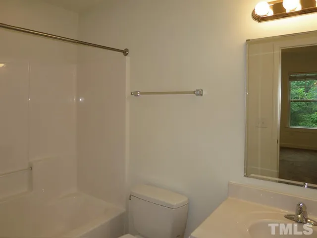 a bathroom with a shower and a toilet