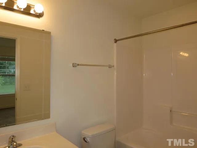 a bathroom with a shower and a toilet