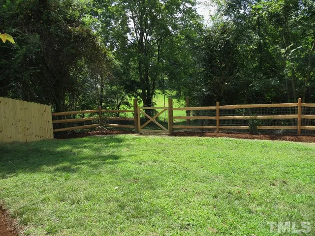 a view of park with bench and garden