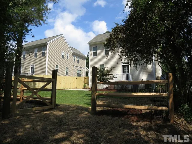 a view of a house with backyard sitting area and garden