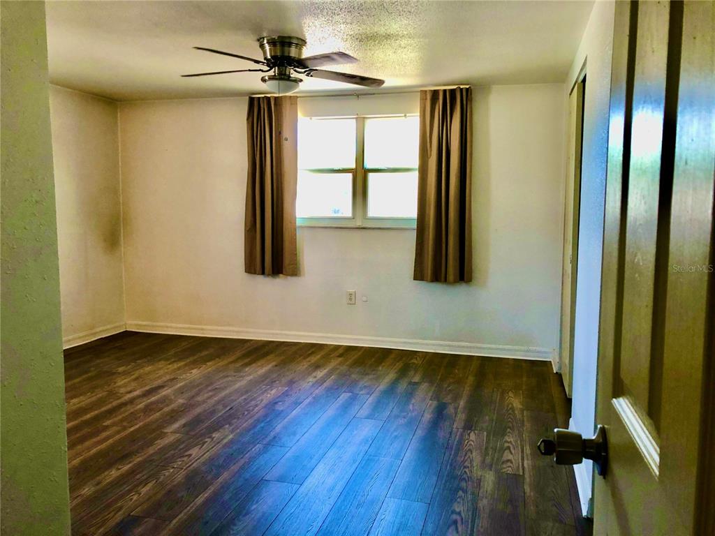 7537 Jasmine Boulevard Port Richey, FL 34668 - Photo 13 of 15 a view of an entryway with wooden floor