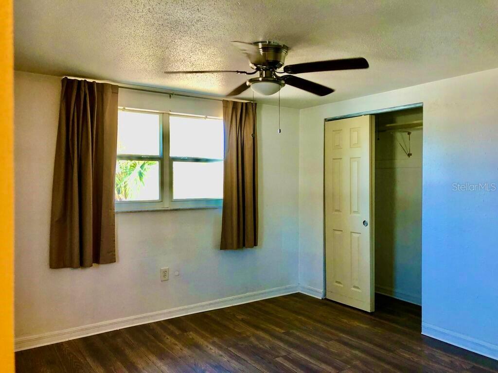 7537 Jasmine Boulevard Port Richey, FL 34668 - Photo 14 of 15 a view of an empty room with wooden floor and a window