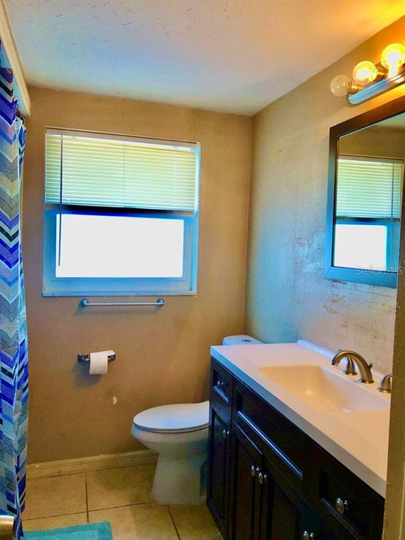 7537 Jasmine Boulevard Port Richey, FL 34668 - Photo 15 of 15 a bathroom with a sink a toilet and a mirror