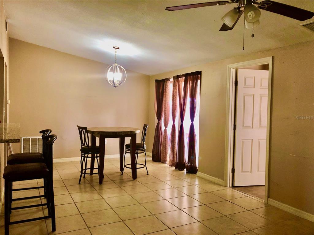 7537 Jasmine Boulevard Port Richey, FL 34668 - Photo 3 of 15 a view of kitchen with furniture and a chandelier