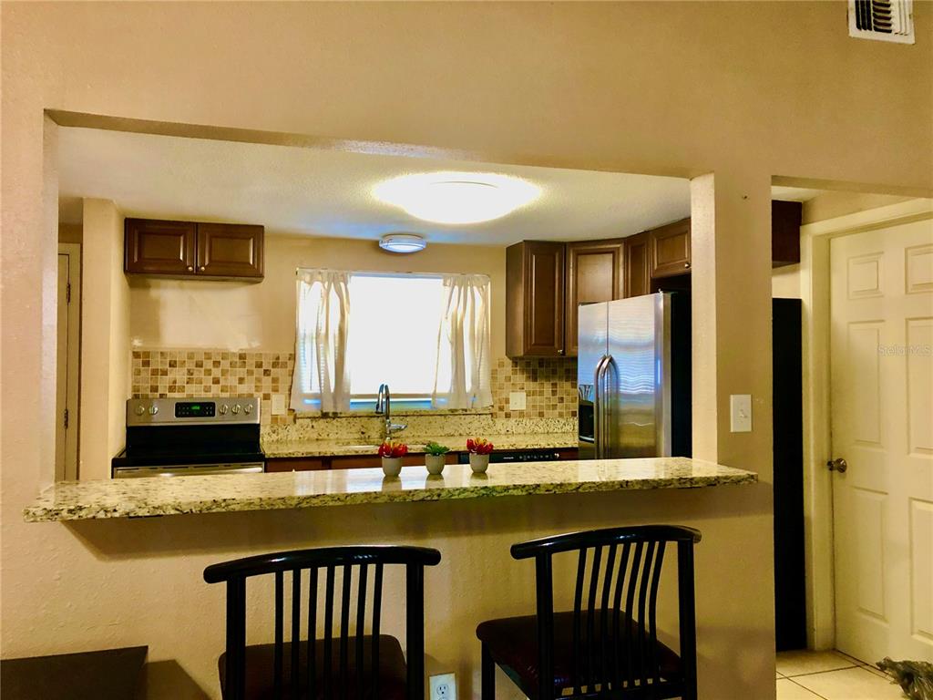 7537 Jasmine Boulevard Port Richey, FL 34668 - Photo 6 of 15 a view of a kitchen with granite countertop and a large window