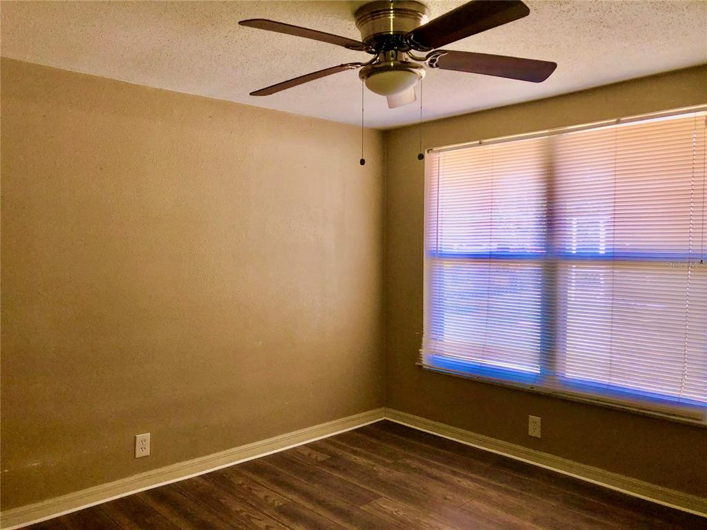 7537 Jasmine Boulevard Port Richey, FL 34668 - Photo 8 of 15 a view of a room with a window and wooden floor