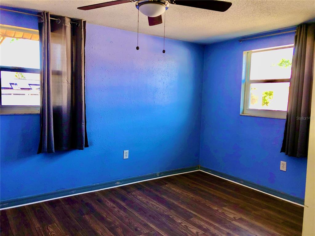 7537 Jasmine Boulevard Port Richey, FL 34668 - Photo 10 of 15 a view of empty room with wooden floor and fan