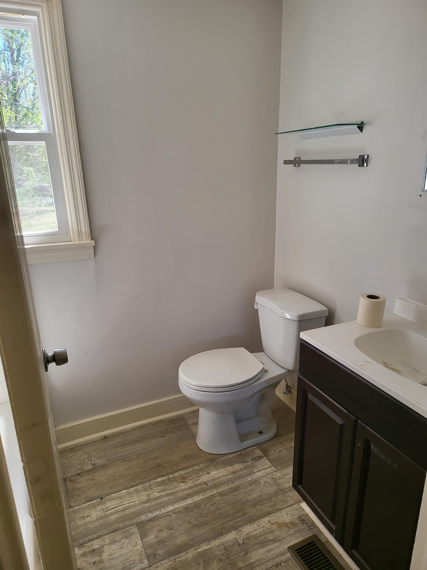 511 Royal Street Raleigh, NC 27607 - Photo 4 of 10 a bathroom with a toilet a sink and a window