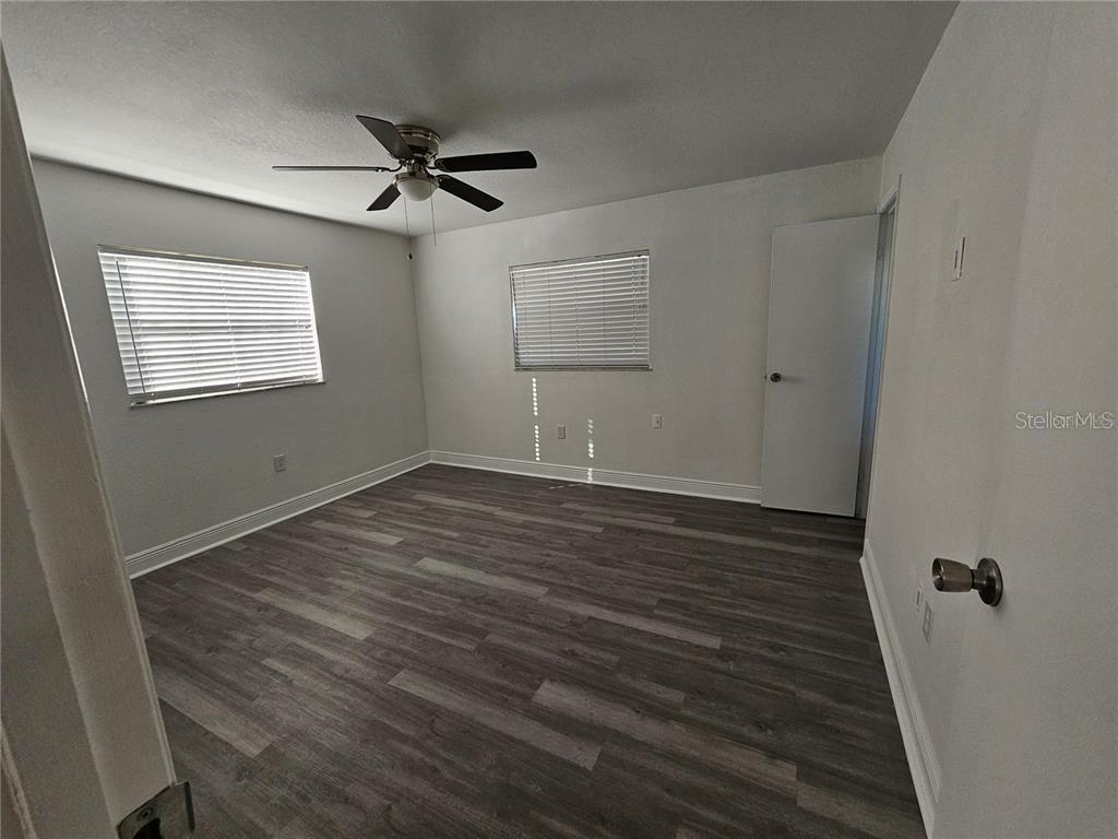 2349 Lisa Street Lake Wales, FL 33898 - Photo 13 of 16 a view of an empty room with wooden floor and a ceiling fan