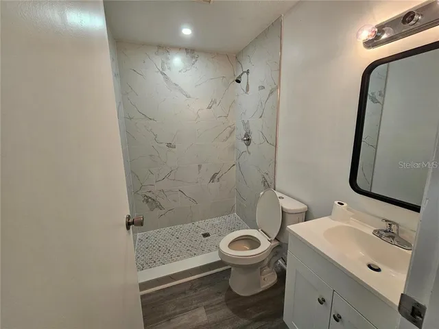 a bathroom with a toilet sink and shower