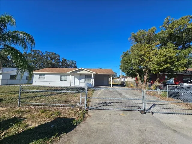 a view of a house with a yard and tree