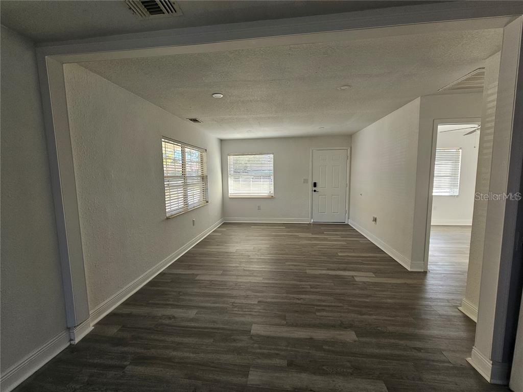 2349 Lisa Street Lake Wales, FL 33898 - Photo 10 of 16 a view of an empty room with wooden floor and a window