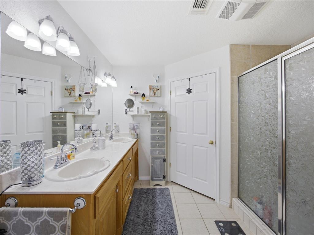 321 Niki Road Paradise, TX 76073 - Photo 19 of 40 a bathroom with a double vanity sink mirror and shower