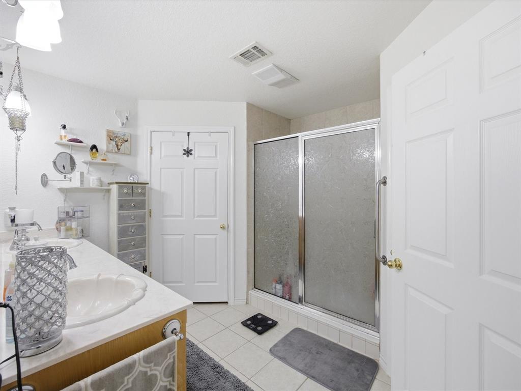 321 Niki Road Paradise, TX 76073 - Photo 20 of 40 a bathroom with a sink a toilet and shower