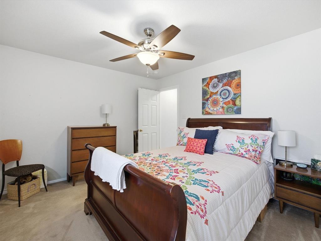 321 Niki Road Paradise, TX 76073 - Photo 21 of 40 a bedroom with a bed and a chandelier