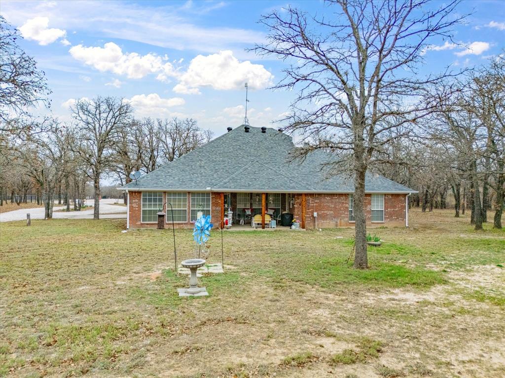 321 Niki Road Paradise, TX 76073 - Photo 27 of 40 a view of a house with a yard