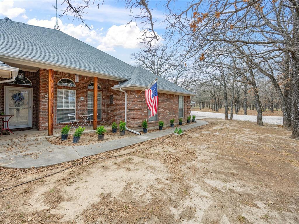 321 Niki Road Paradise, TX 76073 - Photo 29 of 40 a building with trees in front of it