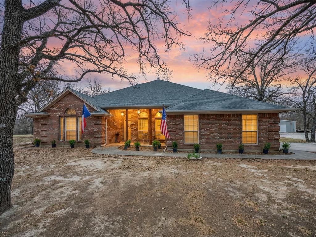 321 Niki Road Paradise, TX 76073 - Photo 3 of 40 a view of a house with a yard