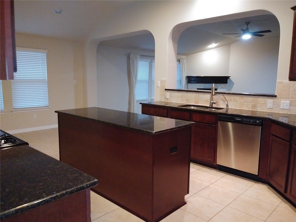 348 Stone View Trail Austin, TX 78737 - Photo 8 of 26 The kitchen features dark granite counter tops and an island with storage space