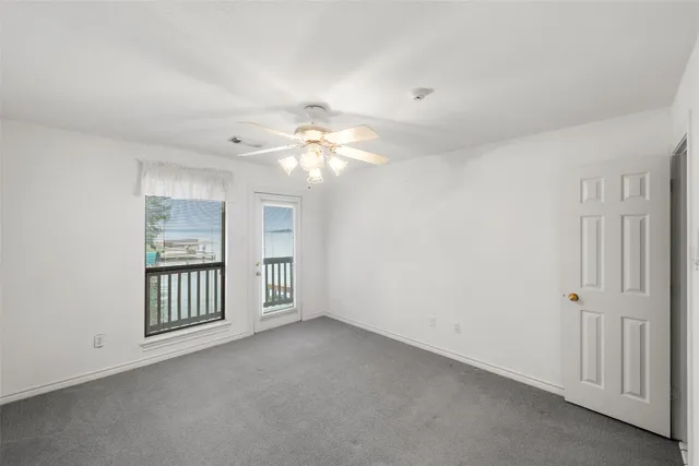 a view of an empty room with a staircase